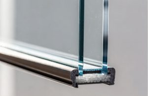Cutaway of a double-pane window showing the sealed argon gas fill between two glass panes with a warm-edge spacer