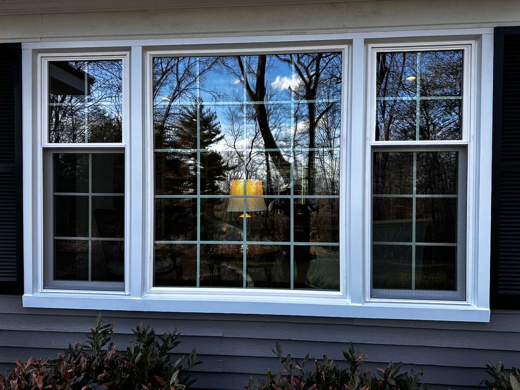 Monarch Contractors crew installing an Okna vinyl replacement window in a Pennsylvania home